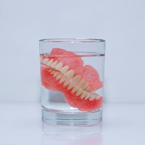 Denture soaks in clear liquid