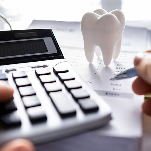 A patient trying to calculate the cost of dental implants