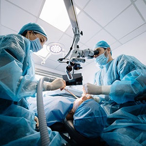 Oral surgeons performing dental implant surgery